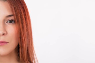 Half face on naturally beautiful redhead woman. Copy space. 