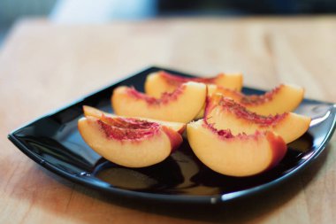 Sliced peach on a plate.