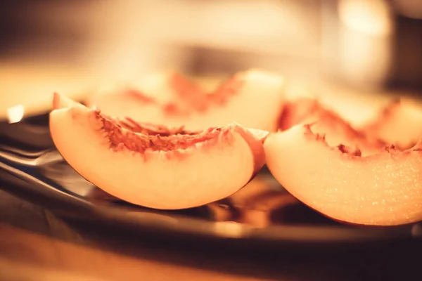 Peach slices on a plate.