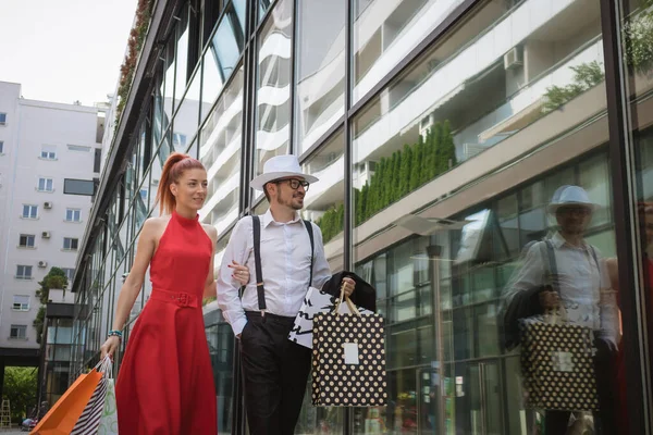 Young Fashionable Couple Carrying Shopping Bags Walking Together City Street — ストック写真