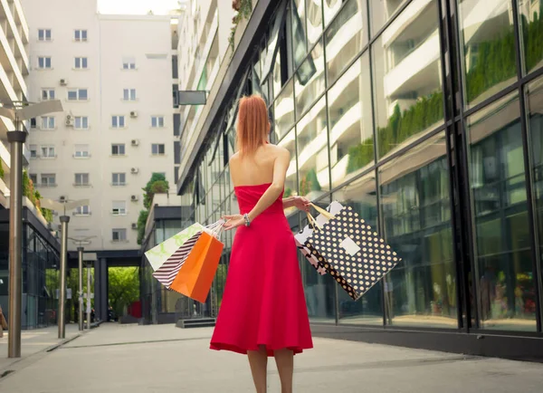 Beautiful Woman Red Dress Holding Shopping Bags Having Fun Street — ストック写真