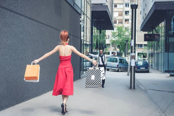 Elegant Woman Red Dress Carrying Shopping Bags Running Boyfriend Embrace — ストック写真