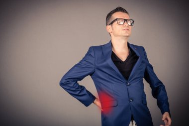 Businessman suffering from lower back pain. Copy space. 