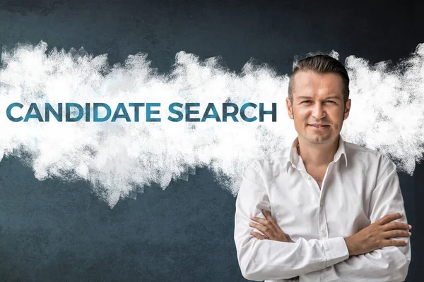 Candidate search. Confident businessman with arms crossed standing next to sign on the wall. Job search concept.