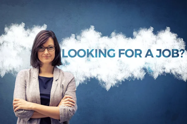 Looking for a job? Confident businesswoman with arms crossed standing next to sign on the wall. Job search concept.