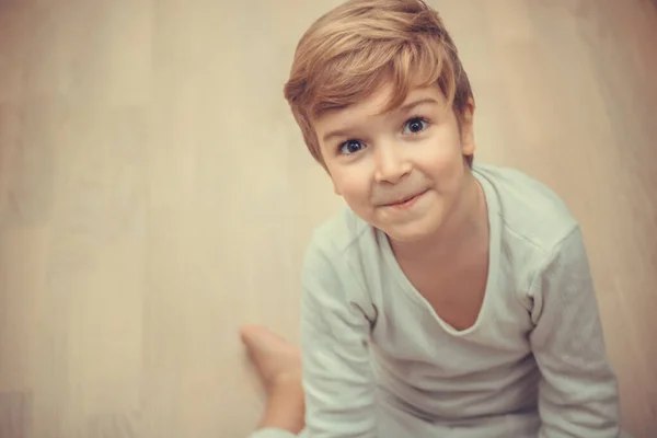 Portret Uśmiechniętego Dzieciaka Siedzącego Podłodze Patrzącego Kamerę — Zdjęcie stockowe
