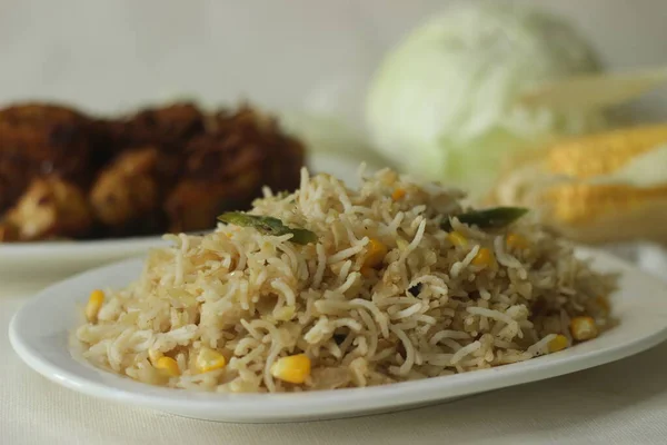 Cabbage corn fried rice. A tasty rice dish with sauteed cabbage and corn flavoured with garlic. A quick meal option served with chicken roast prepared in kerala style. Shot with fresh cabbage and corn