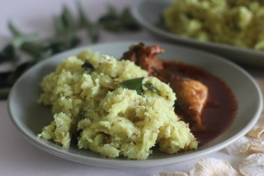 Hindistancevizi, arpacık soğanı, biber, zerdeçal ve köri yapraklı kuru tapyoka. Kırmızı baharatlı uskumru ve köri ile servis edilir. Kerala 'nın popüler yemeği unakkakappa ve balık körisi.