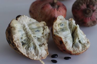 Slices of Red Custard Apple Fruit or Annona Reticulata Bullocks Heart. A fruit which is vary in shape. When ripe, fruit is brown or yellowish, with red highlights and a varying degree of reticulation