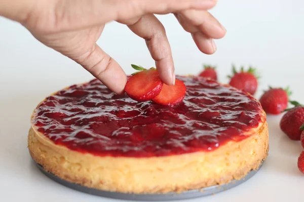 Decorating Strawberry cheese cake with fresh strawberry on top. Silky smooth and creamy cheese cake with homemade fresh strawberry toppings.