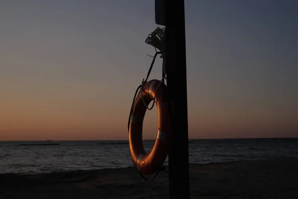 This is a life saving device to prevent drowning. This lifesaver lifebuoy is hanging on a wooden post at Cypremort Point Beach near the Gulf Coast of Louisiana on the Vermilion Bay.