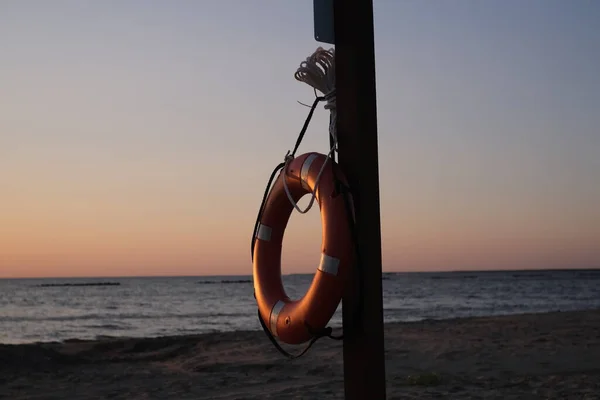 This is a life saving device to prevent drowning. This lifesaver lifebuoy is hanging on a wooden post at Cypremort Point Beach near the Gulf Coast of Louisiana on the Vermilion Bay.