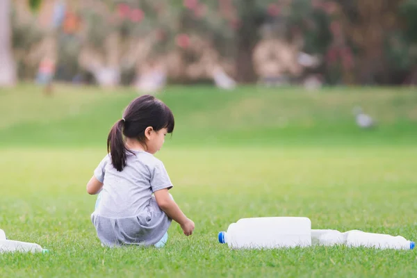 Belakang Melihat Gadis Kecil Mendapatkan Sampah Botol Plastik Rumput Hijau — Stok Foto