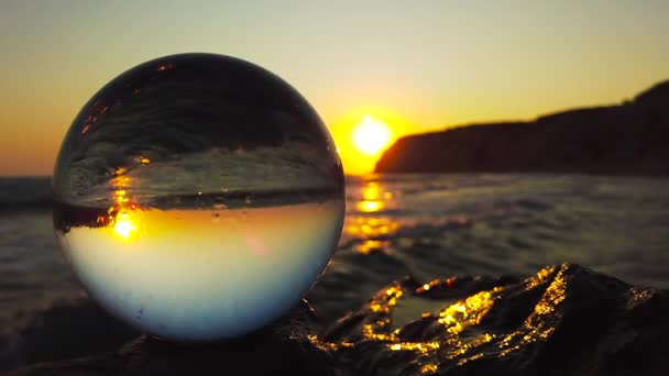 Uma Bola Vidro Está Penhasco Frente Mar Por Sol Quando — Vídeo de Stock