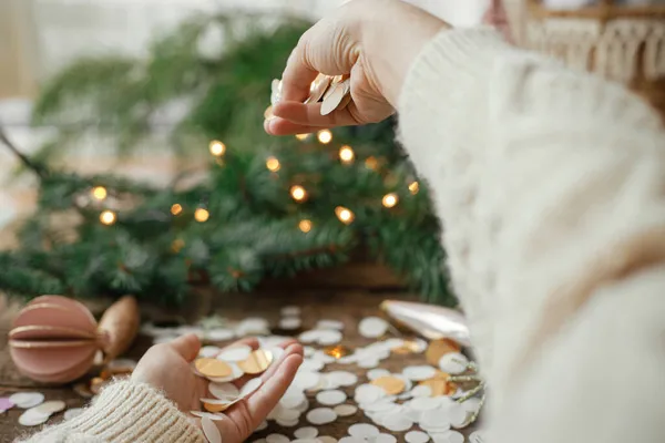 Hands Sweater Holding Golden Confetti Background Christmas Lights Decorations Baubles — Stock Photo, Image