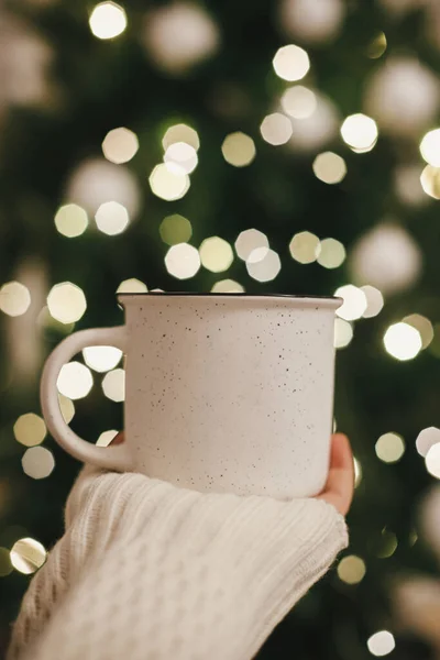 Hand Sweater Holding Stylish Cup Background Christmas Tree Lights Evening — Stock Photo, Image