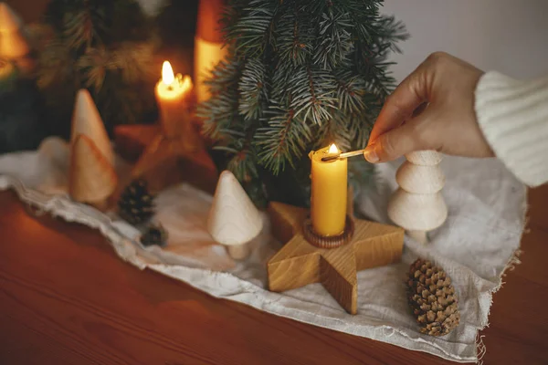 Hand Lighting Christmas Candle Background Pine Trees Decorations Cones Rustic — Stock Photo, Image
