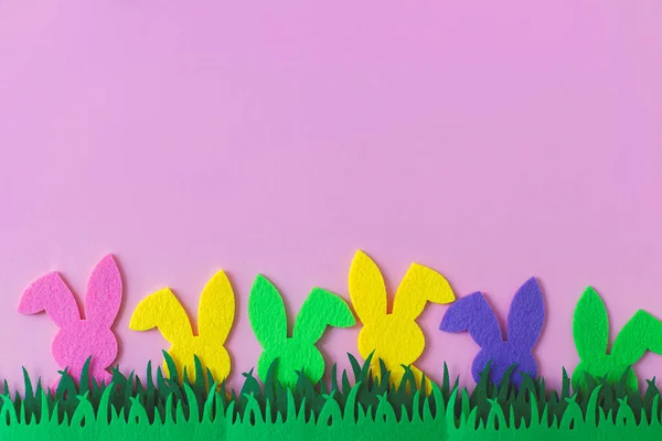 Easter Hunt Concept Colorful Easter Bunnies Grass Pink Background Top — стоковое фото