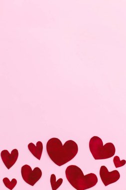 Sevgililer Günün kutlu olsun! Zarif sevgililer günü kalpleri pembe arka planda, metin için yeri olan düz bir şekilde yatıyordu. Sevgililer Günü kartı şablonu. Pembe kağıtta kesilmiş sevimli kırmızı kadife kalpler. Aşk konsepti