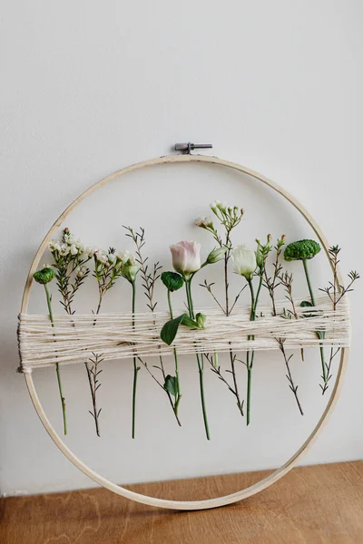 多姿多彩的春天花环 开着美丽的鲜花 白色墙背上有花线的木制圈圈 现代和创意花卉手工装饰 — 图库照片