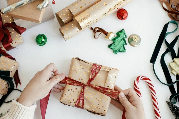 Person Preparing Modern Gift Box Red Ribbon Golden Wrapping Paper —  Fotos de Stock