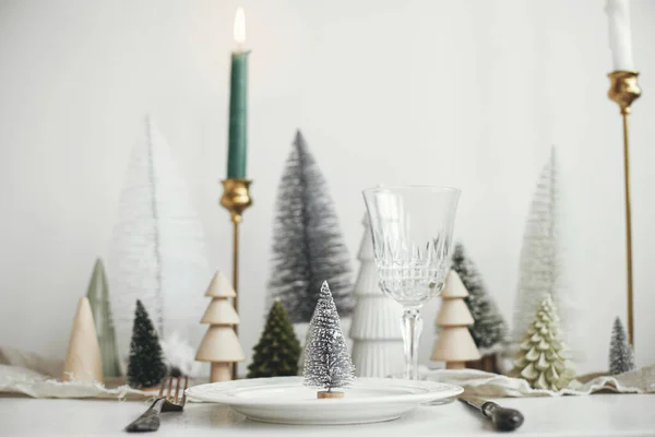 現代のクリスマステーブルの設定 プレート上のスタイリッシュな小さなクリスマスツリー ヴィンテージのカトラリー お祝いのモミや白素朴なテーブルの上の家 テーブルの休日の配置 — ストック写真