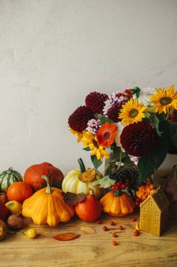 Sonbahar hala hayattır. Şık balkabakları, güz çiçekleri, böğürtlenler, yapraklar, kırsal ahşap masadaki mum. Mutlu Şükran Günleri Mevsimlik tebrik kartı şablonu ve metin için boşluk. Atmosferik düşüş