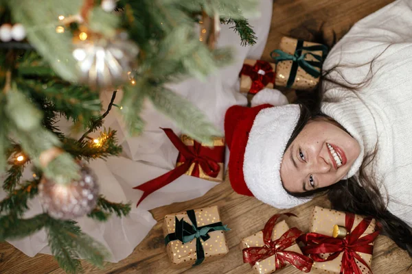 Happy Woman Santa Hat Lying Christmas Gifts Christmas Tree Top — Stock Photo, Image