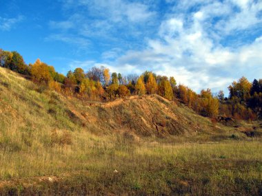 Sonbahar, yüksek bir tepenin tepesinde, açık bulutlu mavi bir gökyüzünün arka planına karşı sarardı.