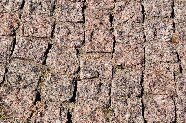 Background, texture of granite stones. The pavement is made of square, granite stones. Background, texture.