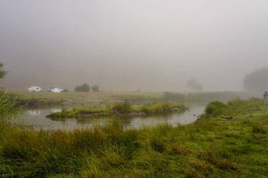 14 August 2022 Eskisehir Turkey Camping in the nature on a foggy morning with caretta caravan