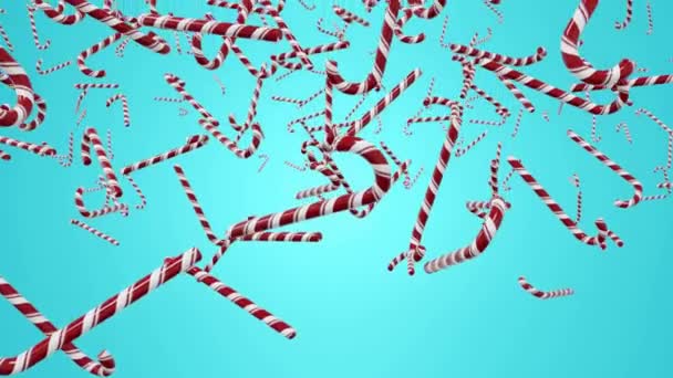 Christmas candy canes fly on blue background. New Years holiday. — Stock Video