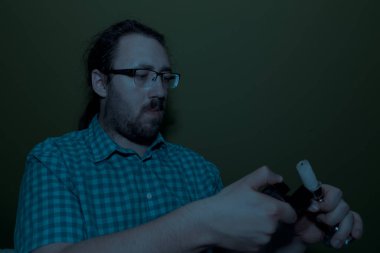 Man in the dark trying to light a candle with a lighter. Blackout concept. power outage scarry