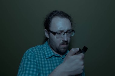 Man the dark looking on a lighter confused. Blackout concept.  power outage scarred