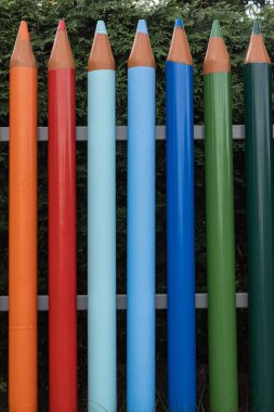 coloured pencil fence kindergarten school blue orange green