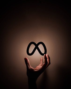  hand reaching out for meta facebook symbol dark illuminated background