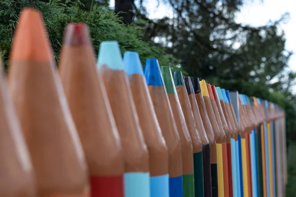 coloured pencil fence kindergarten school blue orange green