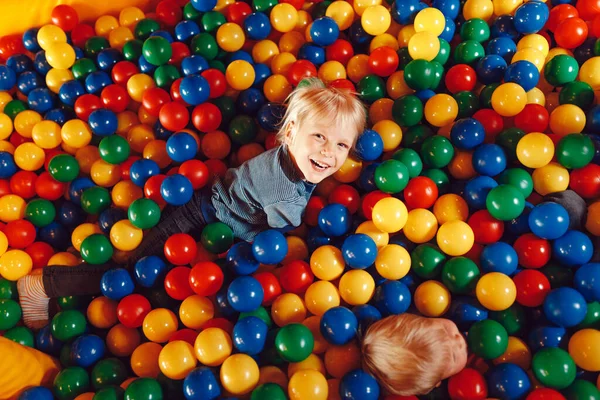 Happy Children Playing in a Ball Pit Pool in Amusement Park. Boys Playing and Having Fun at Children Play Centre