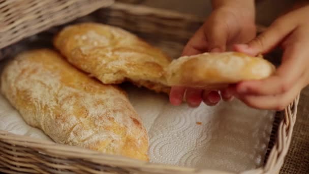 Girl breaking freshly baked ciabatta at home — Stock Video