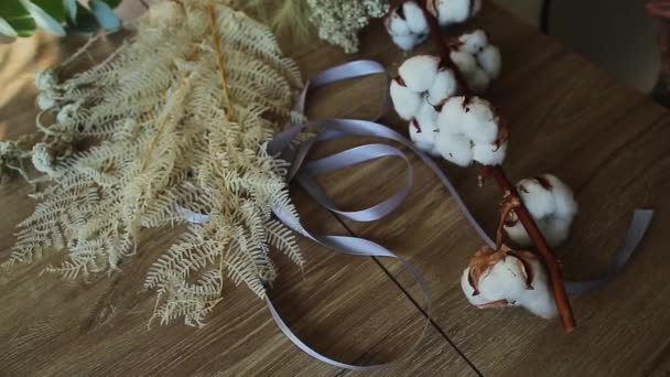 Young woman arranging dried flowers at home — Stock Video