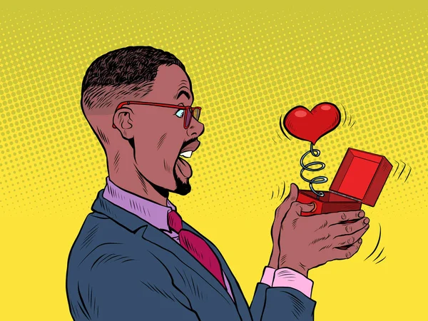 A businessman man looks at a red heart box valentine surprise greeting, love romance — Stockvector