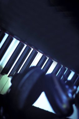 Piyano tuşlarında müzik kulaklıkları. Kimse yok.