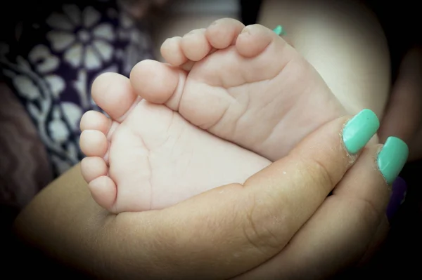 Baby Feet Held Mothers Hand Black Background — Stockfoto