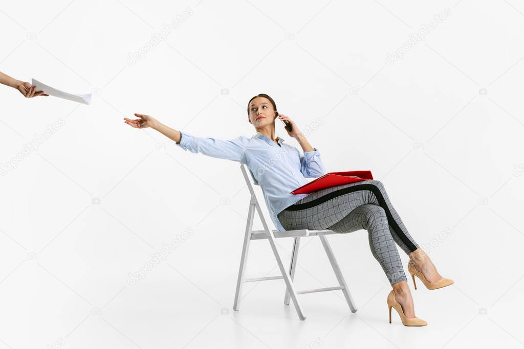 Portrait of young business woman, worker at office isolated over white background