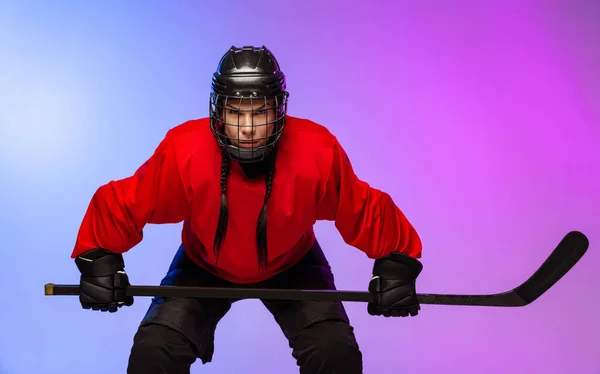 Cropped portrait of professional female hockey player, goalkeeper training isolated over gradient blue purple background. Concentrated player
