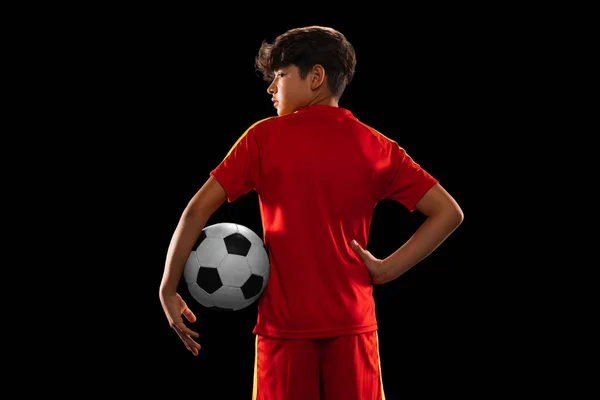 Retrato de corte vista traseira do menino, adolescente, jogador de futebol profissional em uniforme com bola posando isolado sobre fundo branco — Fotografia de Stock