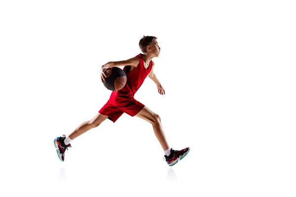 Full-length portrait of boy, basketball player in motion, training isolated over white background — Stock Photo, Image