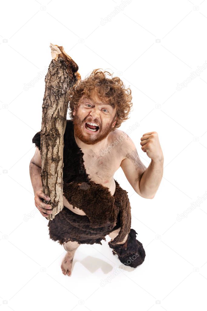 Full-length portrait of primitive man, neanderhal with wooden look showing irritation isolated over white background