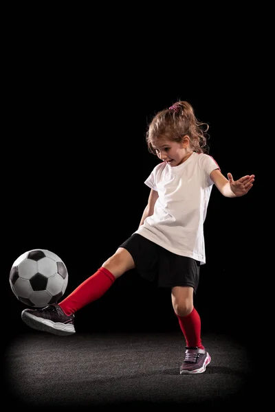Teljes hosszúságú portré játékos lány, gyermek mozgásban, akció, képzés elszigetelt fekete háttér — Stock Fotó