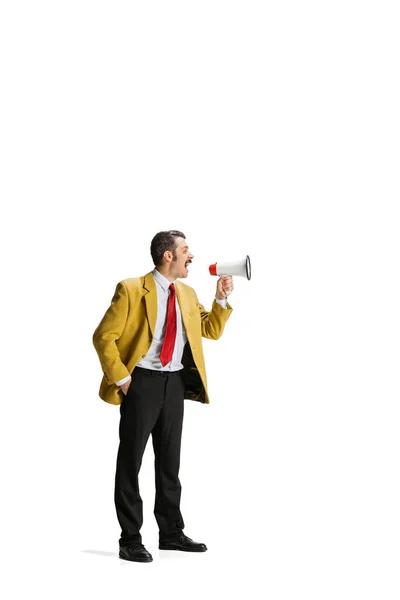 Full-length portrait of man in a suit, worker shouting into megaphone isolated over white background. — Stock Photo, Image